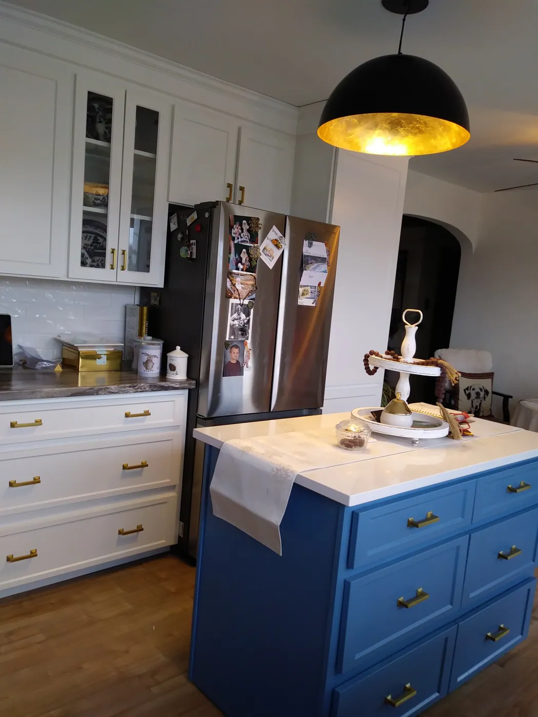 Sprayed white kitchen cabinets with a blue painted island
